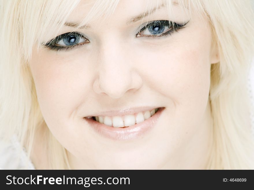 Portrait of the smiling blonde looking directly on you