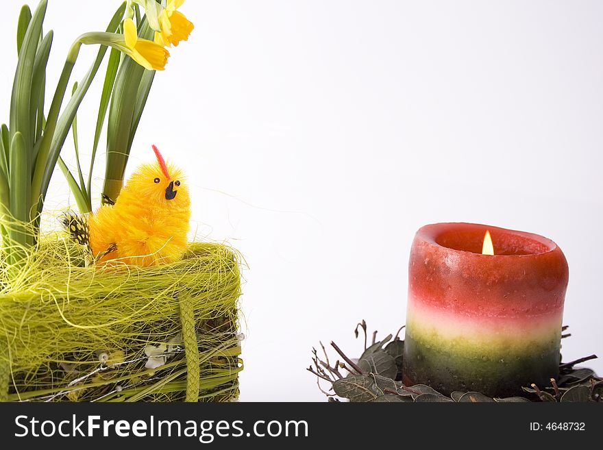 Yellow chick in basketry with some flowers and candle - easter isolated. Yellow chick in basketry with some flowers and candle - easter isolated