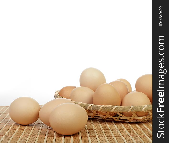 Eggs in basket isolated in white background