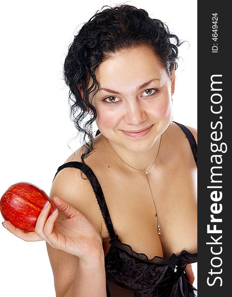 The beautiful girl holds an apple in a hand. The beautiful girl holds an apple in a hand