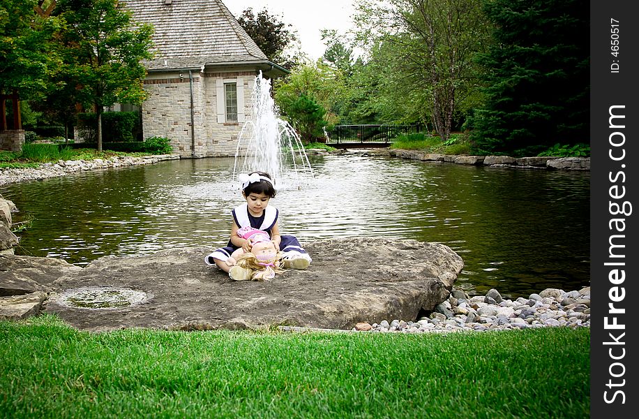 Two year old sitting on grasses with beautiful fall colors in the background. Two year old sitting on grasses with beautiful fall colors in the background