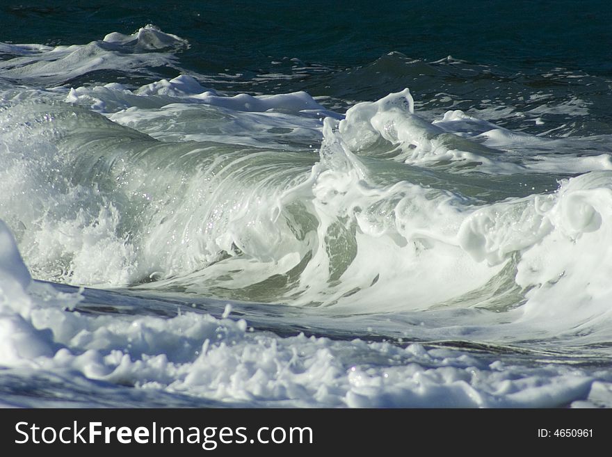 Detail of waves breaking on the shoreline. Detail of waves breaking on the shoreline