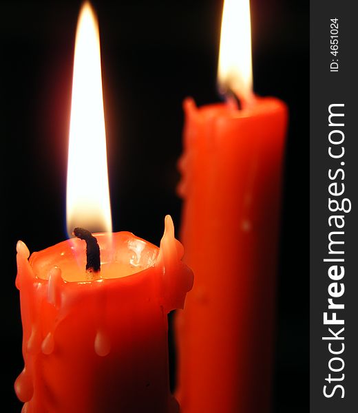 Candle on the black background