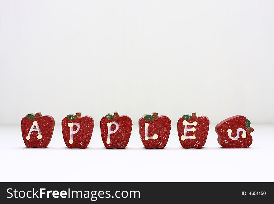 Wooden Apples with letterings spelling apples.