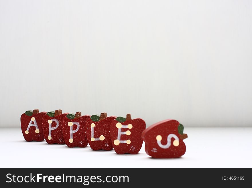 Wooden Apples with letterings spelling apples.