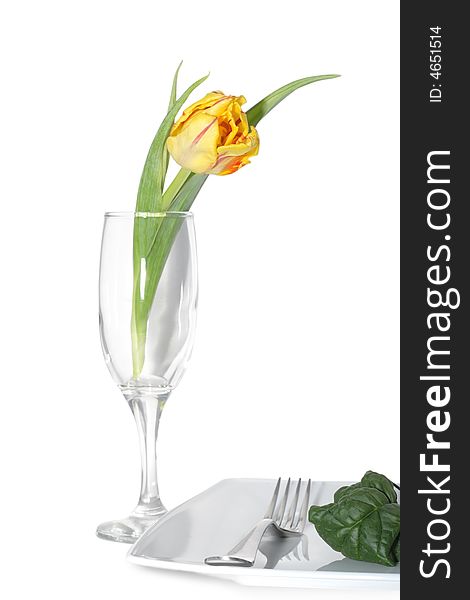 Still life of vegetables on a plete and flower in a glass. Still life of vegetables on a plete and flower in a glass.