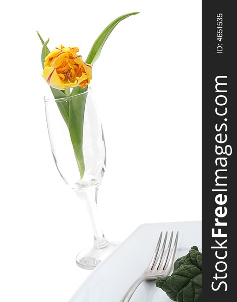 Still life of vegetables on a plete and flower in a glass. Still life of vegetables on a plete and flower in a glass