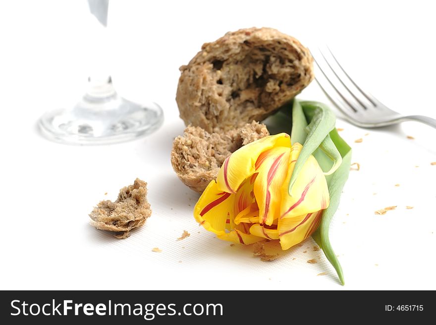 Yellow tulip and a lot of crumbs of bread. Yellow tulip and a lot of crumbs of bread