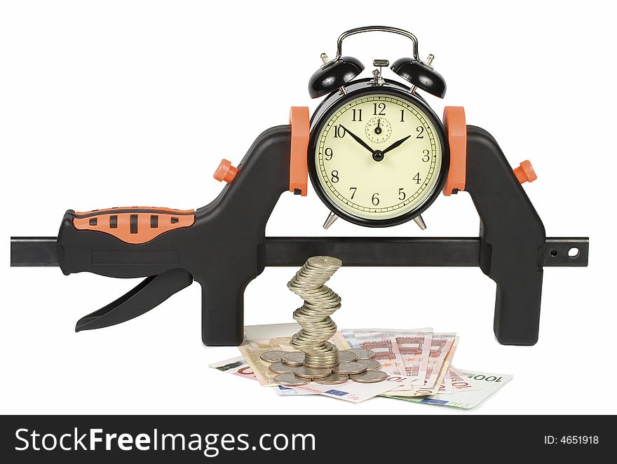 The hours clamped in a manual clamp a tower from coins and a banknote, isolated on a white background. Clipping path included. The hours clamped in a manual clamp a tower from coins and a banknote, isolated on a white background. Clipping path included.