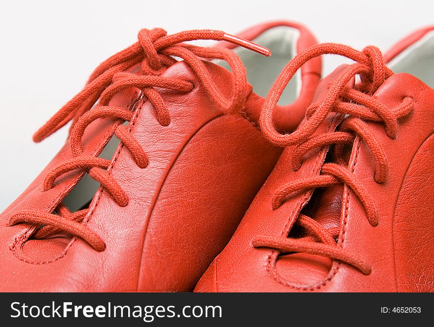 Red shoes, red laces, color background, isolated. Red shoes, red laces, color background, isolated