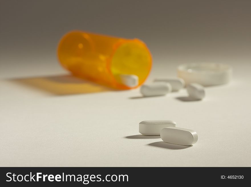 Pills and Fallen Bottle with Dramatic Lighting.