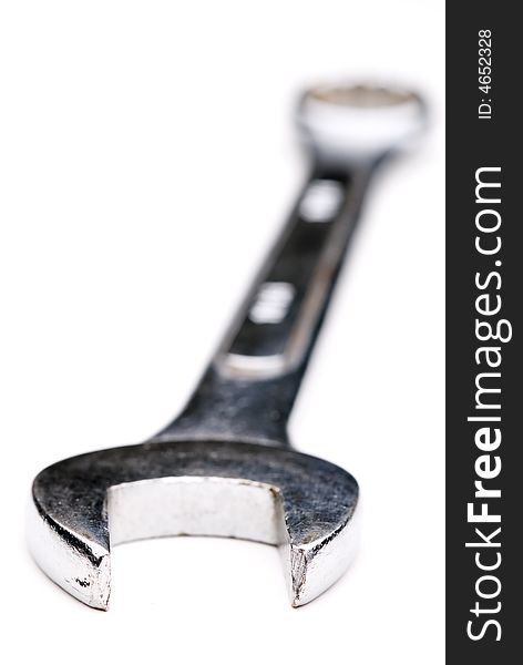 Macro of a well worn wrench  on white
