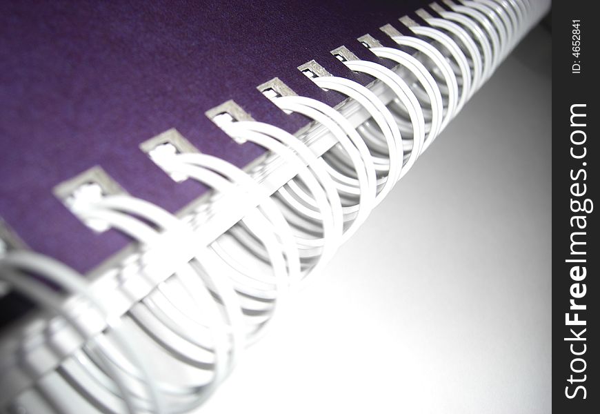 Closeup view of a ringed notebook, symbolizing the dynamic of a business company. Closeup view of a ringed notebook, symbolizing the dynamic of a business company