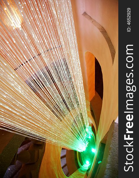 Detail of a multicolour fibers illumination system inside the central pole of a rinascimental spiral staircase. Rome, Italy. Detail of a multicolour fibers illumination system inside the central pole of a rinascimental spiral staircase. Rome, Italy.