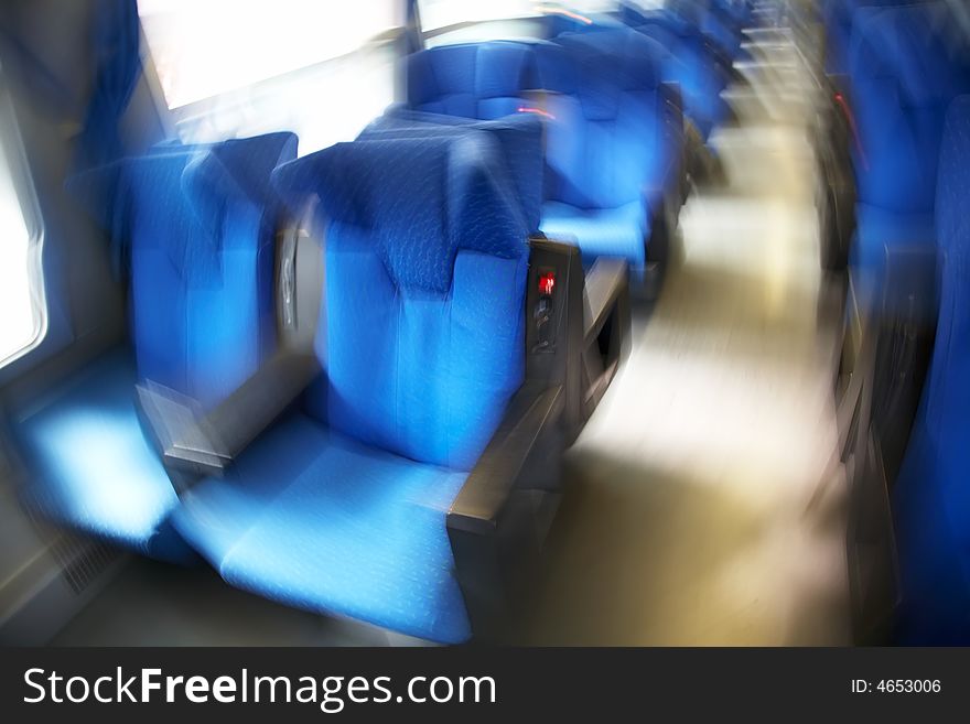 Vacant seats inside an empty passenger train. Horizontal frame. Blur effect. Vacant seats inside an empty passenger train. Horizontal frame. Blur effect.