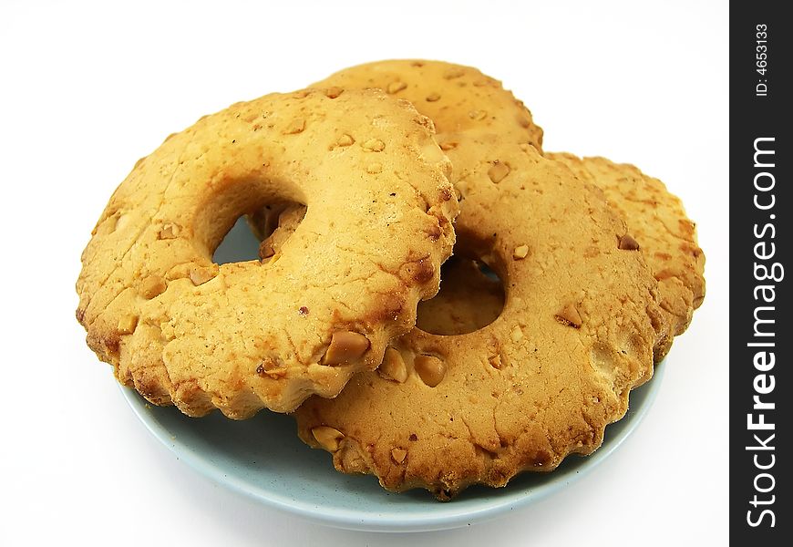 Beautiful cookies with nuts on a plate on a white background