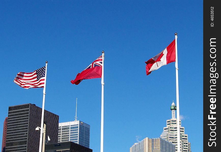 Three flags on the background of blue sky