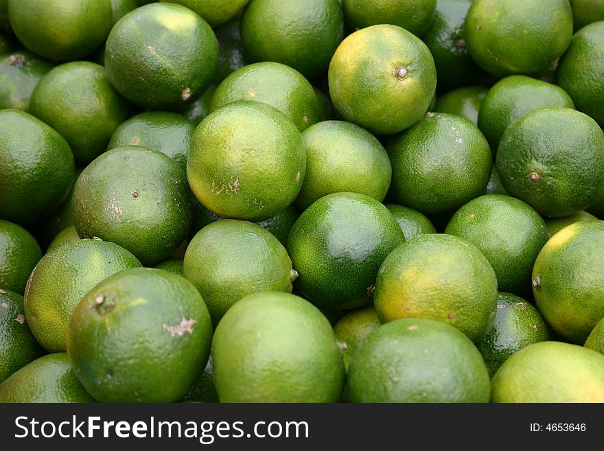 Not ripe Orange Citrus fruits. Lemons, oranges and limes. Not ripe Orange Citrus fruits. Lemons, oranges and limes.