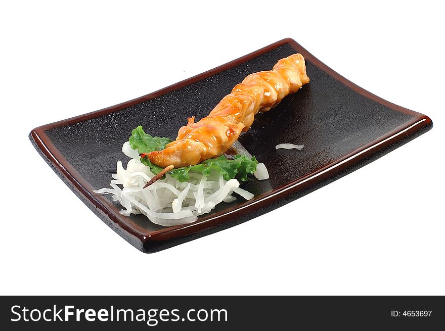 Shish kebab from a salmon on a dish on a white background