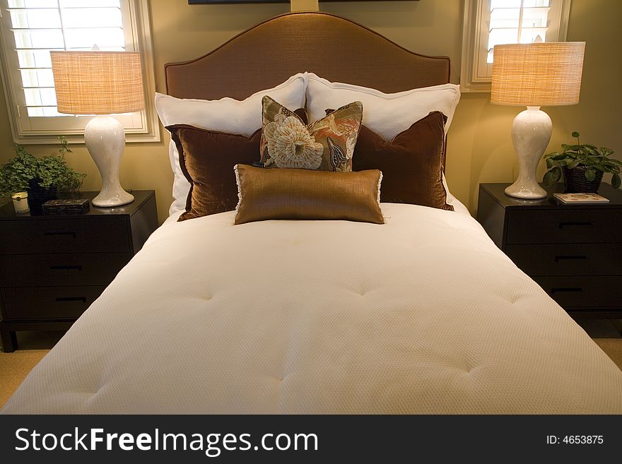 Comfortable bedroom and modern decor in a luxury home. Comfortable bedroom and modern decor in a luxury home.