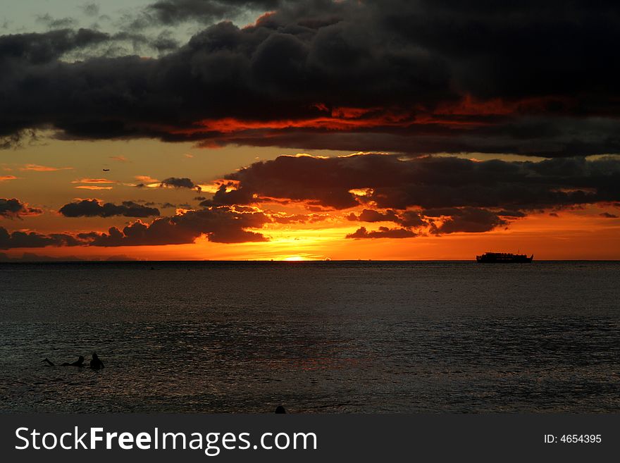 Sunset at Waikiki Beach with rain clouds, Oahu, Hawaii. Sunset at Waikiki Beach with rain clouds, Oahu, Hawaii