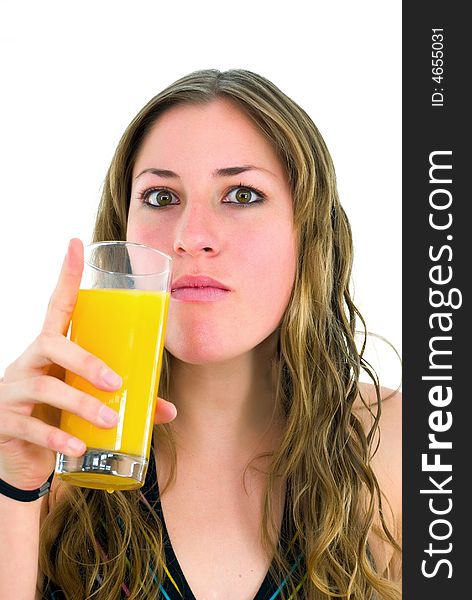 Gorgeous girl with mouthful of orange juice