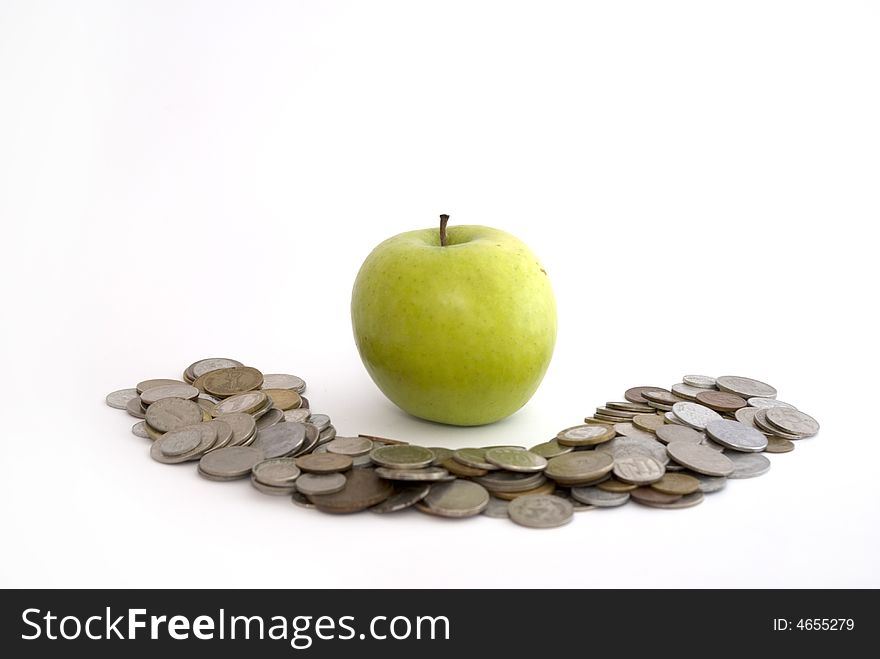 Green apple on the heap of coins