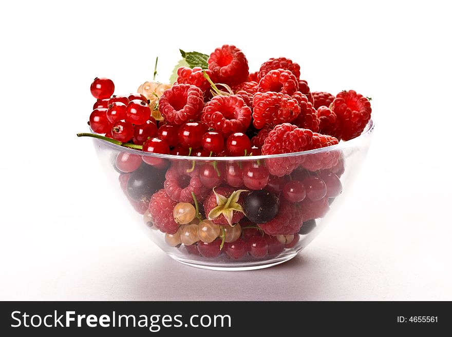 Raspberry and currant on the glassy bowl