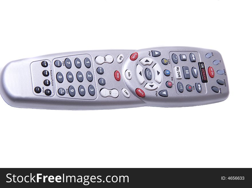 A silver universal remote control with many buttons on white background. A silver universal remote control with many buttons on white background