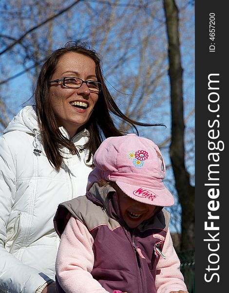 Young girl and children smiling in tandem seesaw.