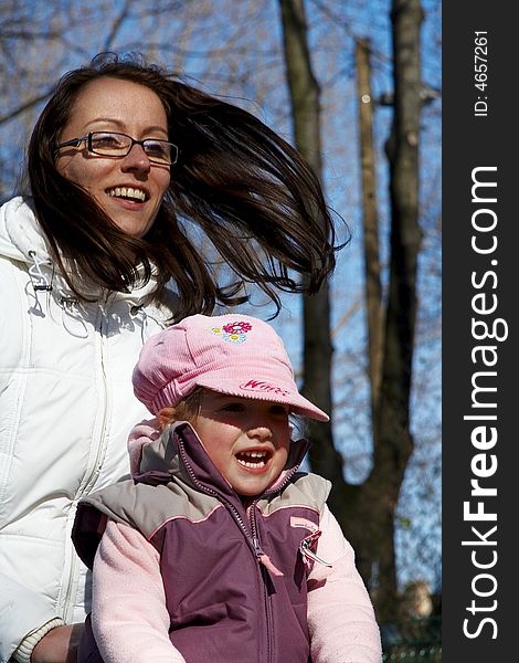 Young girl and children smiling in tandem seesaw.