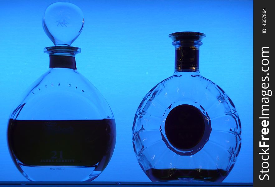 Whisky bottles as contour on a blue lighted background