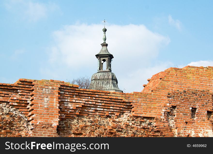 Ruin of old castle, in background the tower of church