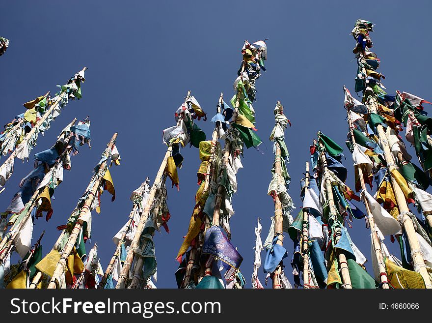Long poles are totally covered of buddhist flags in siberia. Long poles are totally covered of buddhist flags in siberia