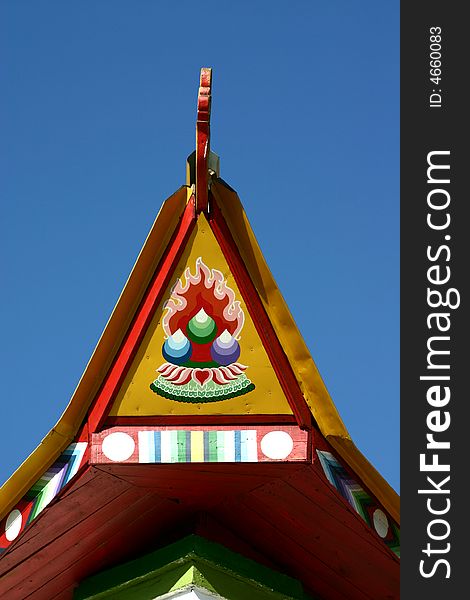 The top of a buddhist temple in a blue sky in siberia