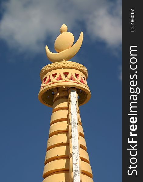 The top of a buddhist stuppa on a blue sky in siberia, symbol of the sun and the moon. The top of a buddhist stuppa on a blue sky in siberia, symbol of the sun and the moon