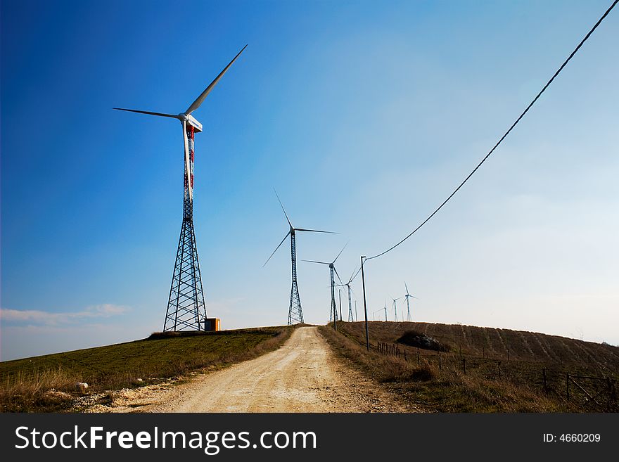 Road through the ecologic generators on top of a hill. Road through the ecologic generators on top of a hill