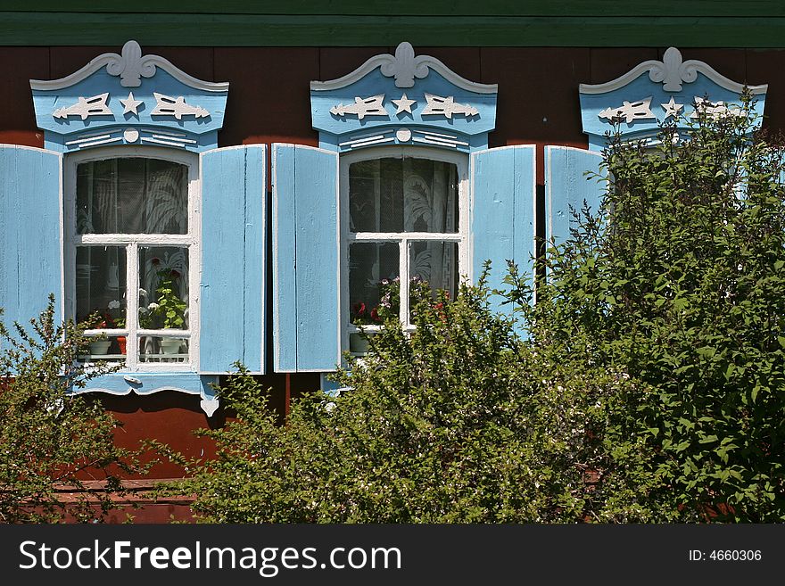 Beatiful colored windows of a datcha, traditional wood home of siberia. Beatiful colored windows of a datcha, traditional wood home of siberia