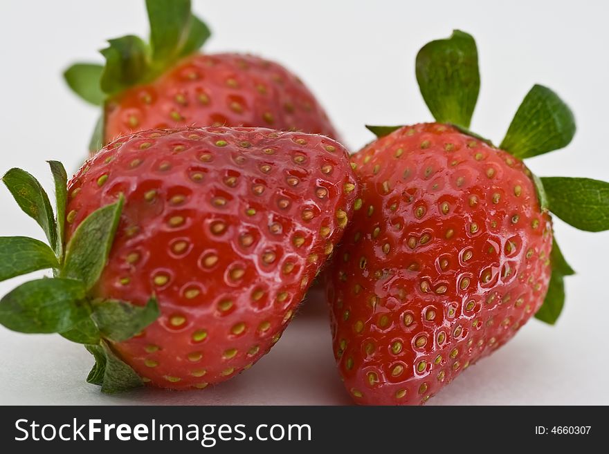 Isolated group of three red ripe strawberries on white background. Isolated group of three red ripe strawberries on white background