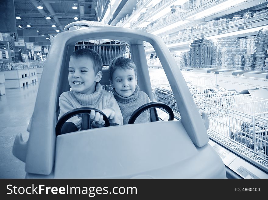 Children in  toy automobile in  supermarket