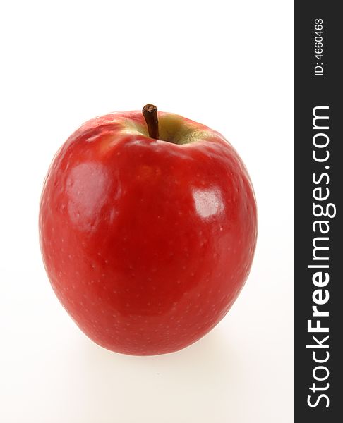 A juicy red shiny apple isolated on white. A juicy red shiny apple isolated on white.