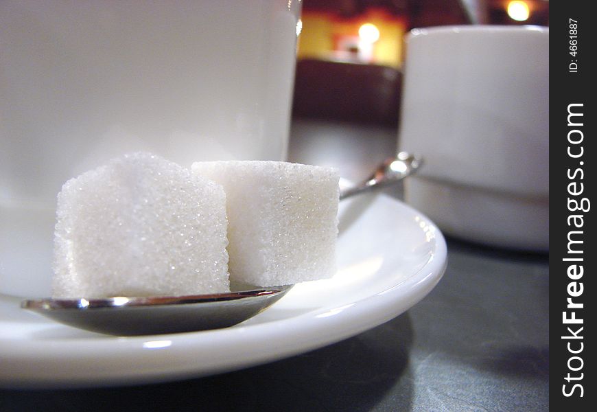 Cup and two pieces of sugar