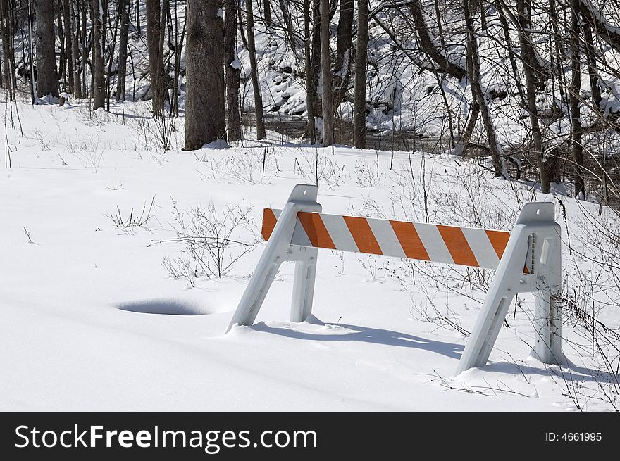 Barricade in snow in wooded area