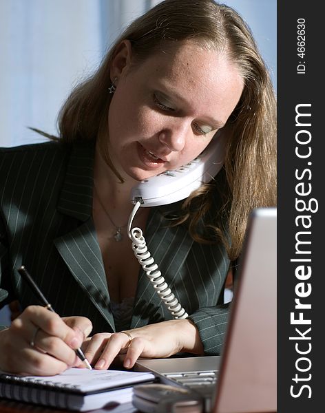 Woman in a business suit on the phone