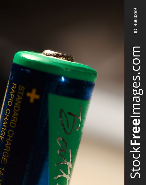 A aa rechargeable battery on white showing the positive charge side. A aa rechargeable battery on white showing the positive charge side.