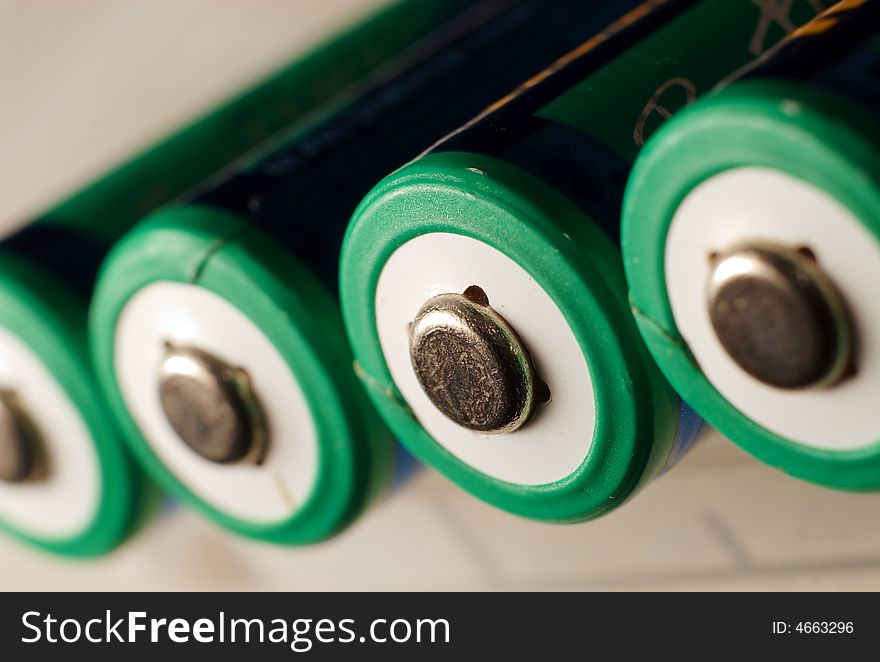 A aa rechargeable battery on white showing the positive charge side. A aa rechargeable battery on white showing the positive charge side.