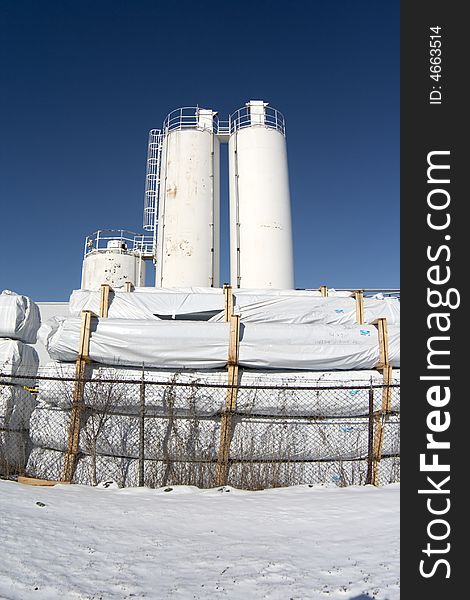 Chemical combinate with snow and blue sky