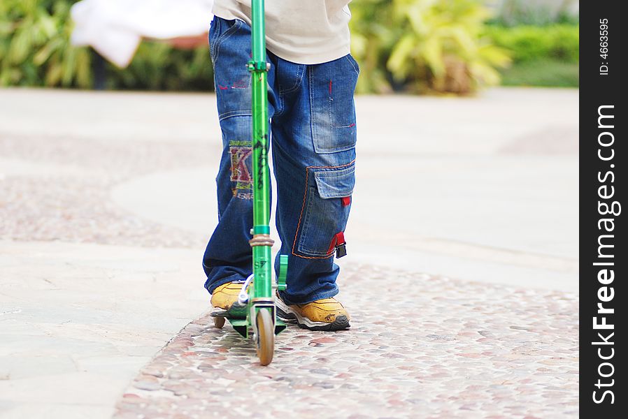 A boy playing and running with a pedal cycle,or push bike. A boy playing and running with a pedal cycle,or push bike.