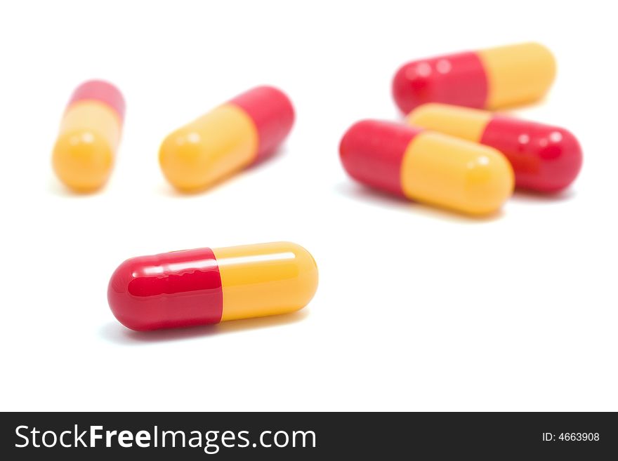 Red and yellow capsule pills isolated
