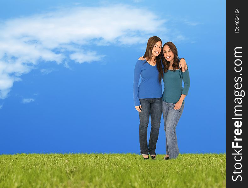 Two girls standing on the grass outdoor. great concept for spring or summer. Two girls standing on the grass outdoor. great concept for spring or summer